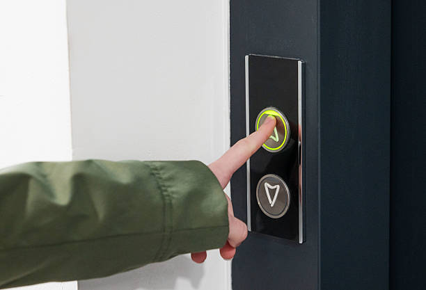istock Person pressing illuminated doorbell button on modern black panel indoors. 2209512045