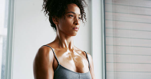 istock Thinking, training and woman in gym, sweating and workout with break, resting and wellness. Healthy person, athlete and runner in center, challenge and exhausted with fatigue, tired and fitness 2209512104