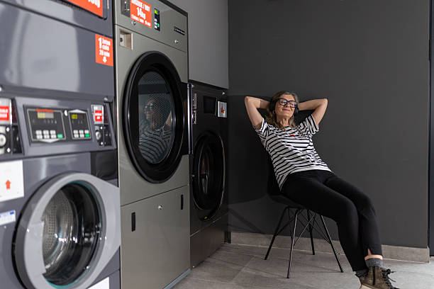 istock Woman relaxing while waiting for the washing machine to finish 2209512957