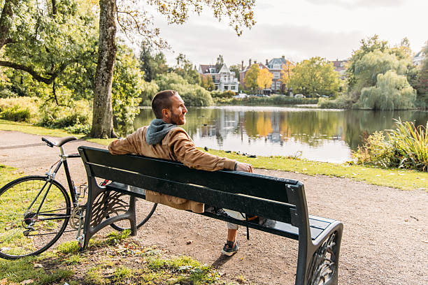 istock Man Relaxing by Idyllic Lakeside on a Sunny Day 2209513577