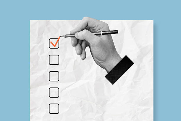 Hand drawing checklist mark on paper. Listing priority and needs concept