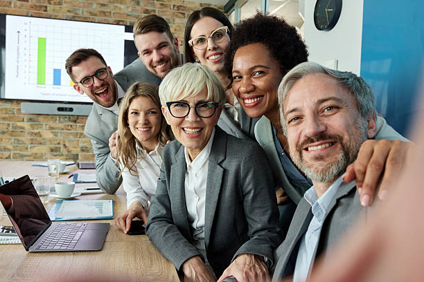 istock Happy business team taking a selfie in the office. 2209515175