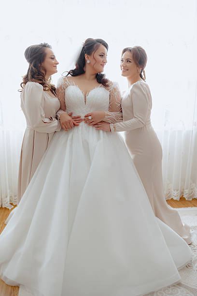 istock Three women are standing in front of a window 2209517922