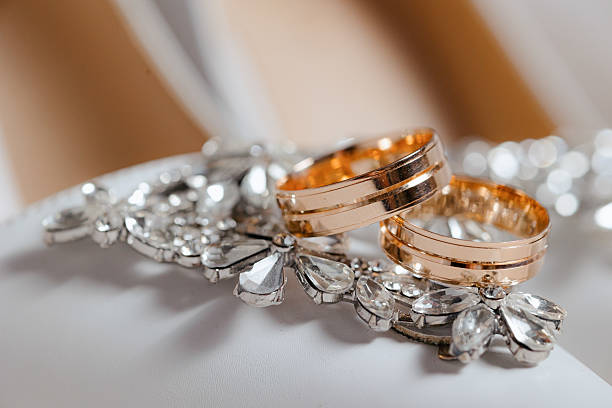 istock A pair of gold and silver wedding rings are on a white surface 2209518040