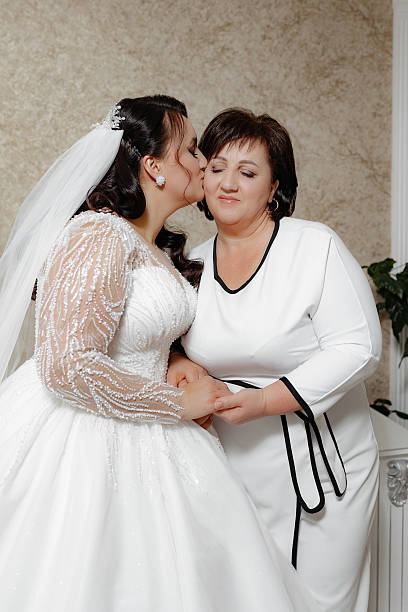 istock A woman is kissing a bride's cheek 2209518284