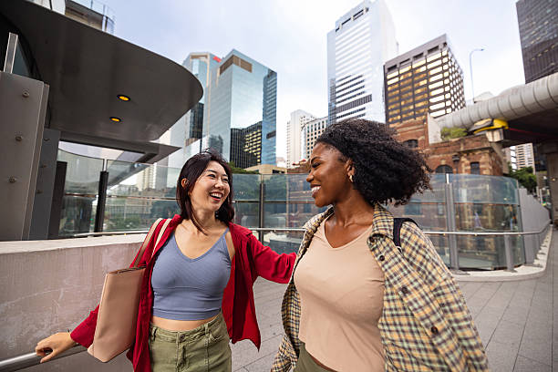 istock Two friends enjoying a conversation outdoors in an urban city setting 2209521137