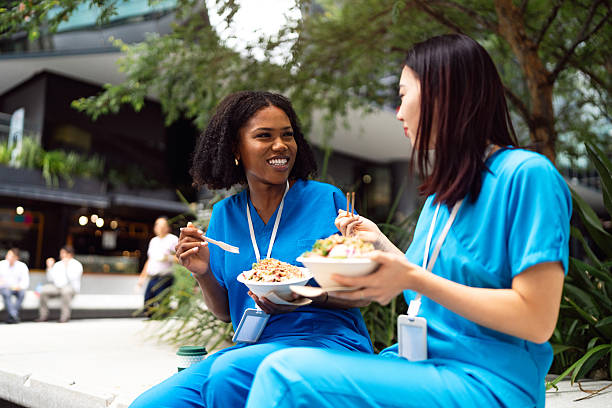 istock Multiracial healthcare professionals enjoying a break outdoors while dining and socializing in the city 2209521817