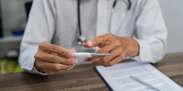 istock Examining Health Tools. A doctor explaining medical tools during a patient consultation. 2209522597