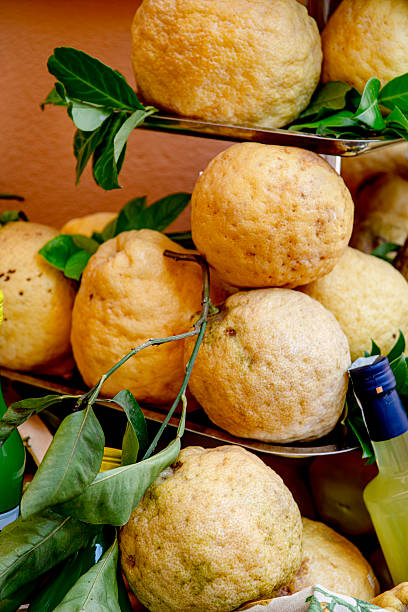 Group of  citron fruit  in a market stall. Front view.