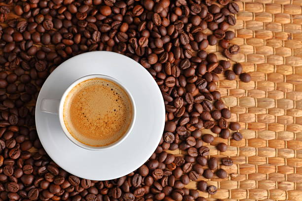 istock Top view of White Espresso Mug Placed on Toasted Coffee Bean Background 2209526234