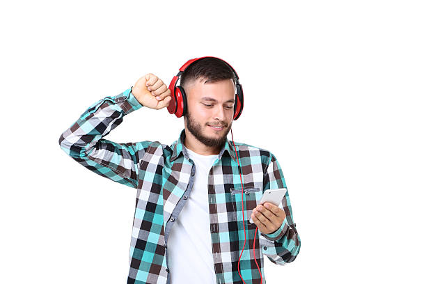 istock Young man with red headphones and smartphone on white background 2209526263