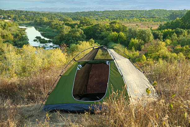 istock One camping tent among plants outdoors on sunny day 2209526360