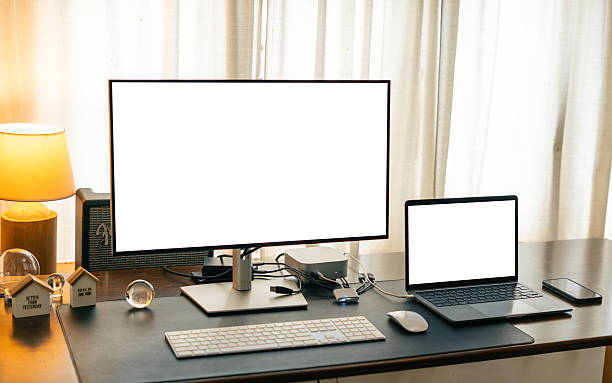 istock Desktop and laptop computers on a home desk, mockup screen 2209526675