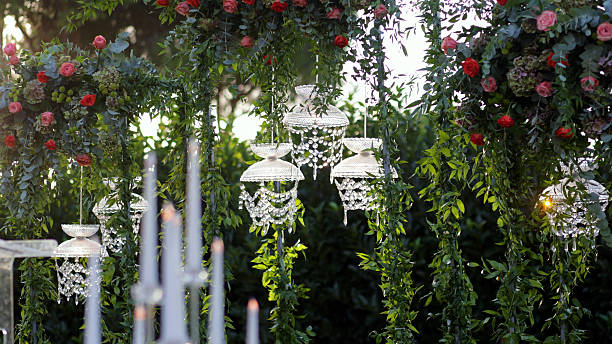 Beautiful floral arrangements used as table decorations at a wedding ceremony. The image captures the romantic and festive atmosphere of a wedding, featuring carefully arranged flowers that add elegance and charm to the celebration. Perfect for themes related to weddings, event planning, floral design, and special occasions.