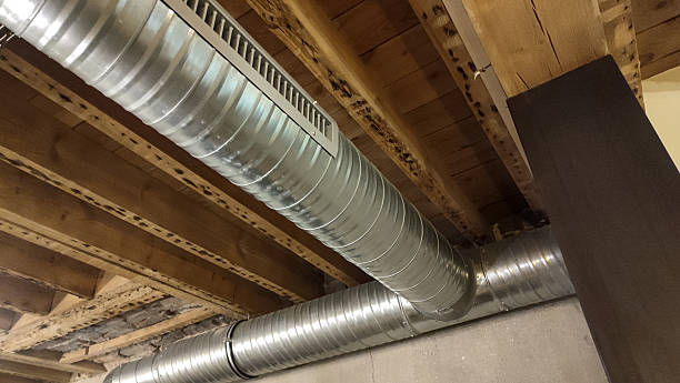 istock Exposed metal air duct system on a wooden ceiling with visible beams. 2209530995