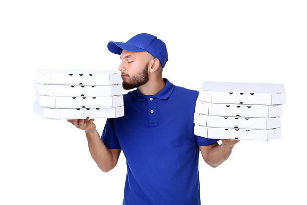 istock Delivery man with pizza in cardboard boxes isolated on white background 2209531514