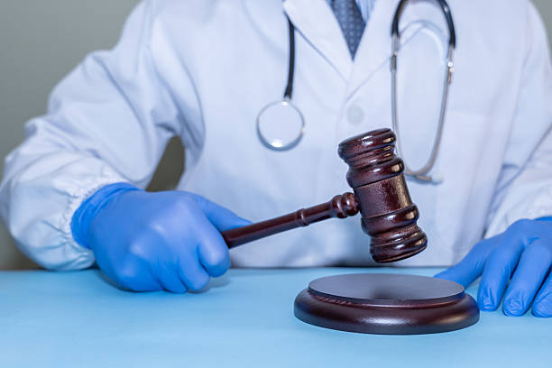 istock Forensic doctor with stethoscope and gavel. 2209531854