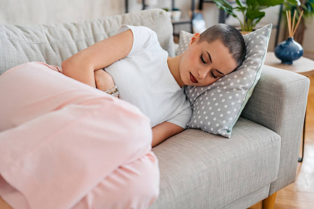 istock Young Woman With A Buzz Cut Sleeping On The Sofa At Home 2209532092