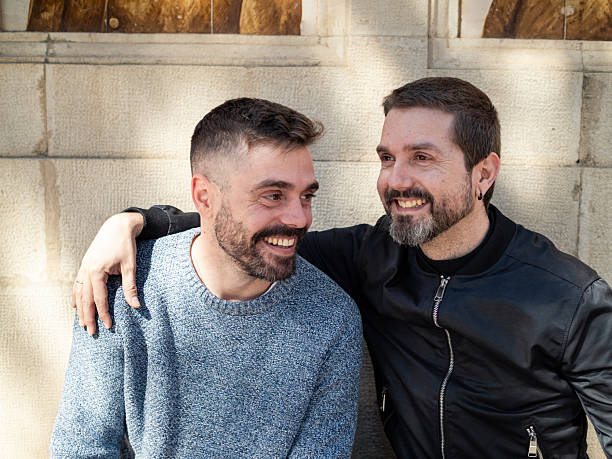 istock Two men enjoying a cheerful moment in a sunny urban setting 2209532389