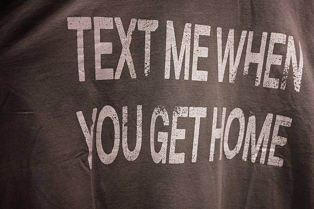istock Closeup of a motivational text printed on a monochromatic fabric surface. Text me when you get home. 2209532834