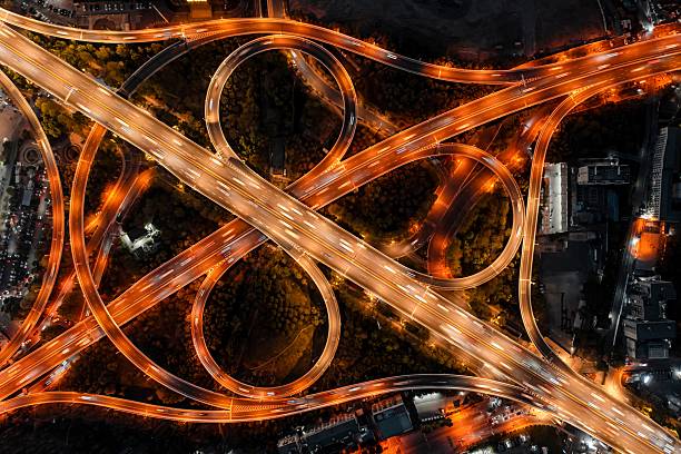 istock Aerial view of illuminated highway interchange at night. 2209537538
