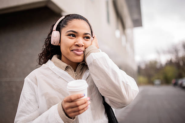 istock Young woman walking in a city 2209537991