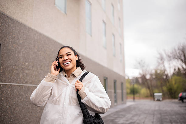 istock Young woman talking on her smartphone while walking through a city 2209537998