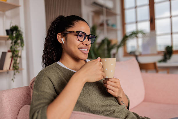 istock Young woman relaxing and drinking coffee at home 2209538418