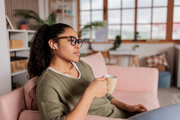 istock Young woman relaxing and drinking coffee at home 2209538436