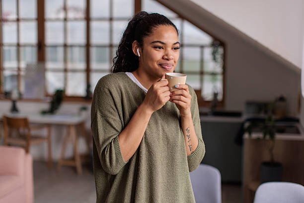 istock Young woman relaxing and drinking coffee at home 2209538516