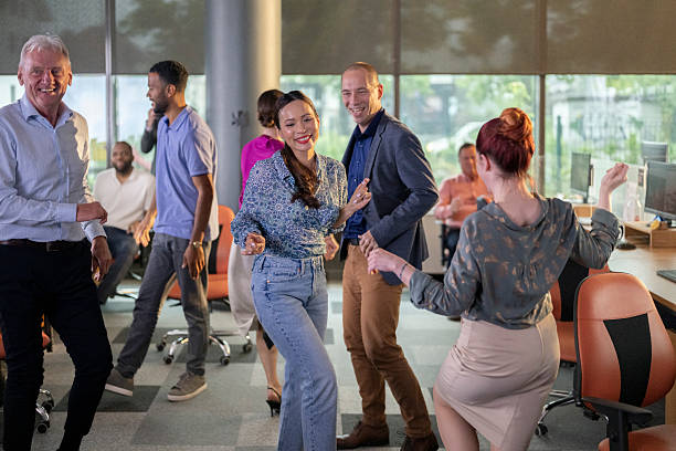 istock Diverse Business Team Dancing and Celebrating Success in Modern Office Space 2209543400