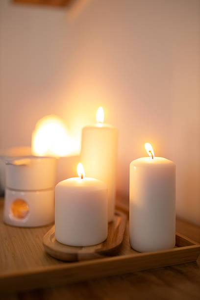 istock Atmospheric, burning candles and an essential oil warmer, creating a warm, relaxing home spa ambiance 2209545574