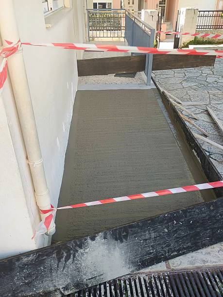 istock Freshly Poured Concrete Pathway Secured with Safety Tape 2209547894