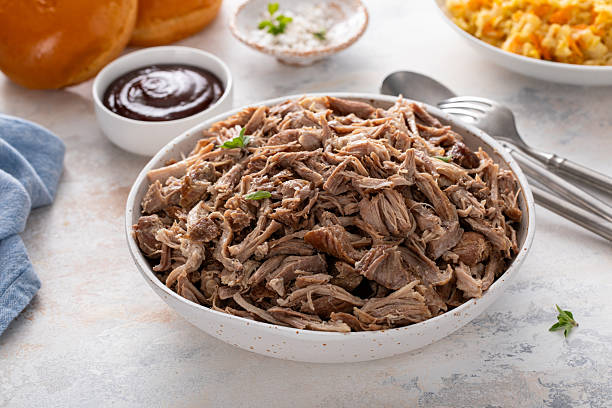 istock Pulled pork or carnitas cooked in a slow cooker served in a bowl to make sandwiches 2209551783