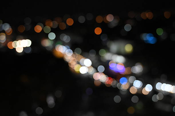 istock Defocused Image Of Illuminated City At Night 2209554214