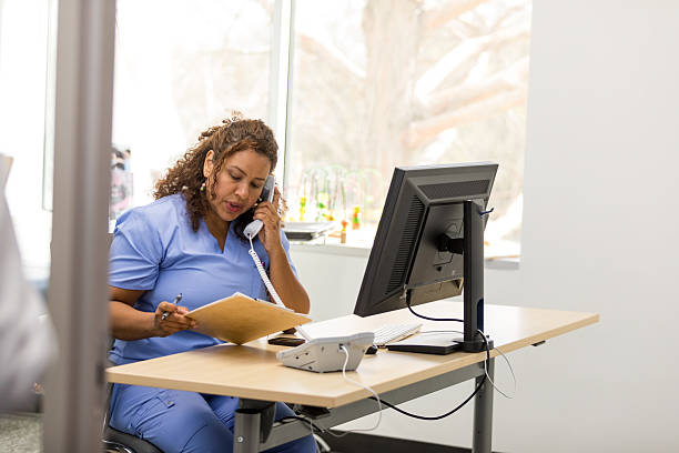 istock Hispanic Female Doctor on Phone, Using Computer in Office 2209560404