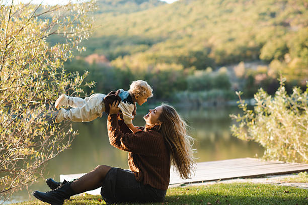 istock Mother with kid daughter over nature background 2209560509