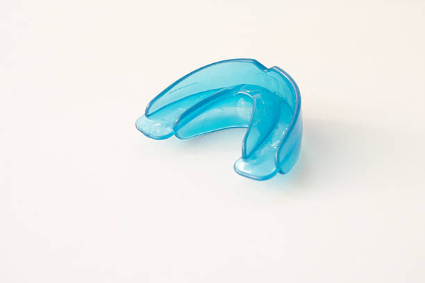 istock Dental simulator for teeth alignment. dental trainer equalize growing teeth, correct bite Teen and child orthodontic oral health care concept. Blue mouthguard on white background 2209562612