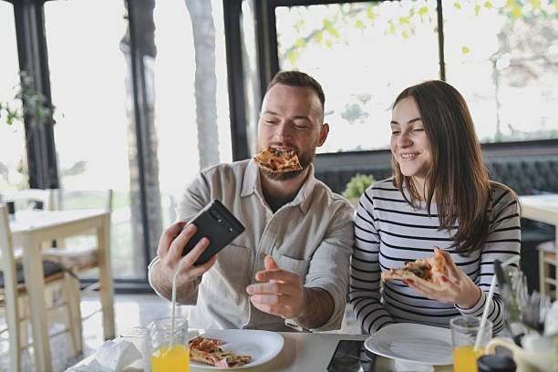 istock Smiling Couple Taking Pizza Selfie With Smartphone at Restaurant 2209562660