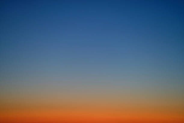 Gradient sky with blue and orange hues at sunset. Natural background with soft color transition. Sky backdrop for design and print