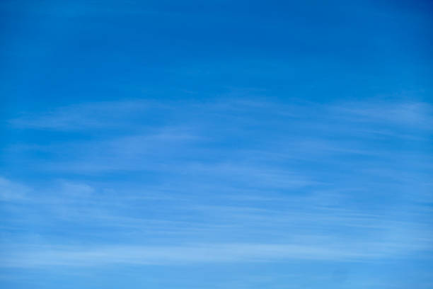 istock Clear blue sky with soft wispy clouds. Natural background with copy space for design and print. 2209563853