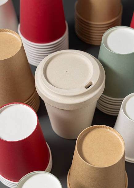 istock New multicolor paper cups and reusable bamboo coffee cup on a gray closeup, mockup 2209565741
