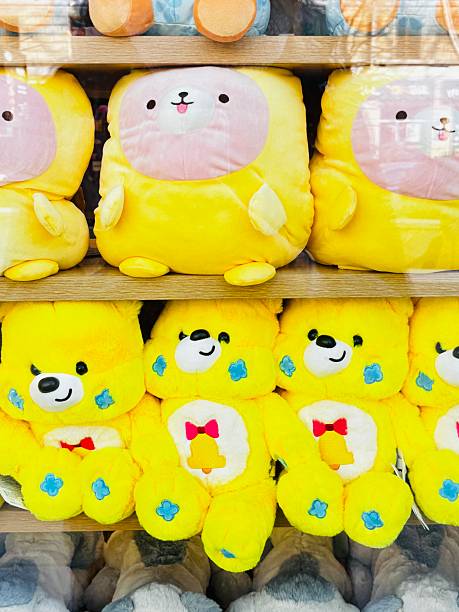 istock Row of yellow stuffed animals on a shelf 2209566785