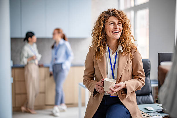 istock Cheerful businesswomen engage in discussions and teamwork in a modern office setting 2209571636