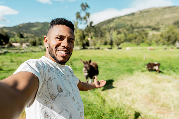 istock Young man taking selfie on a farm - camera point of view 2209571832