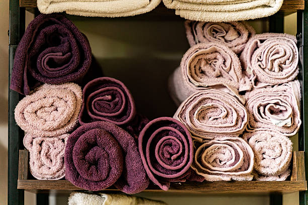 Close-up of rolled up bath towels inside a cabinet