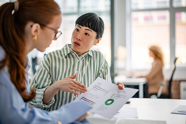 istock Modern office setting where a diverse group of women engages in productive teamwork and discussion for business strategies 2209574833