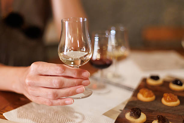 istock woman enjoying wine tasting experience with a delicate glass 2209575107
