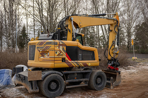 istock Yellow wheeled excavator with geometric patterns at construction site 2209575278