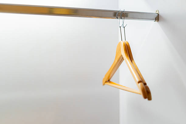 istock Clothes hangers are hanging on a rail in the wardrobe. 2209576211